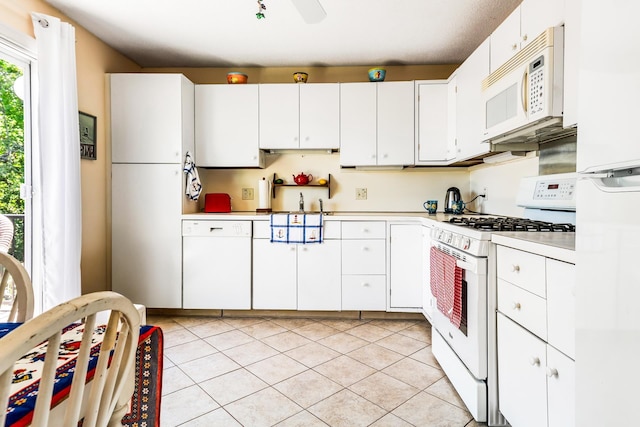 39 Hilltop Pl Unit 39, New London, NH 03257 - kitchen featuring white appliances, light countertops, light tile patterned flooring, and white cabinetry