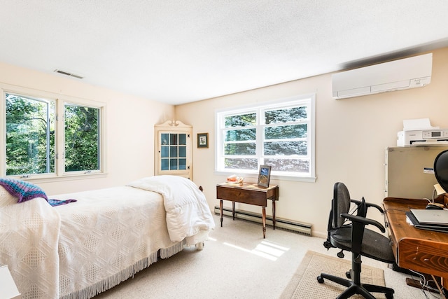 39 Hilltop Pl Unit 39, New London, NH 03257 - bedroom featuring an AC wall unit, a baseboard radiator, multiple windows, and light carpet