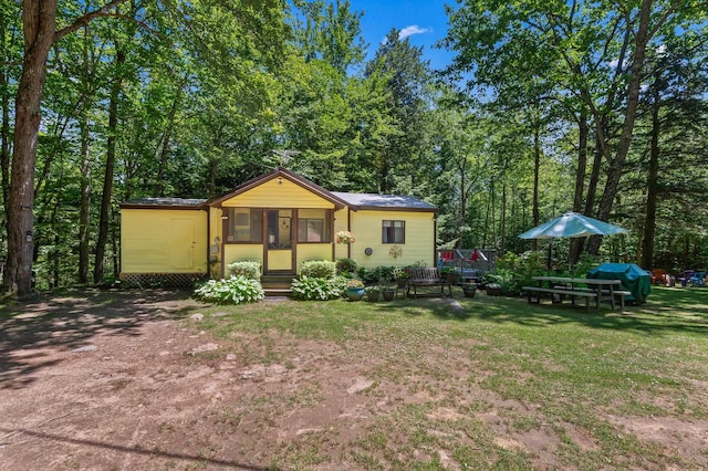 38 Range Rd, Holderness, NH 03245 - back of property with entry steps, a lawn, and driveway