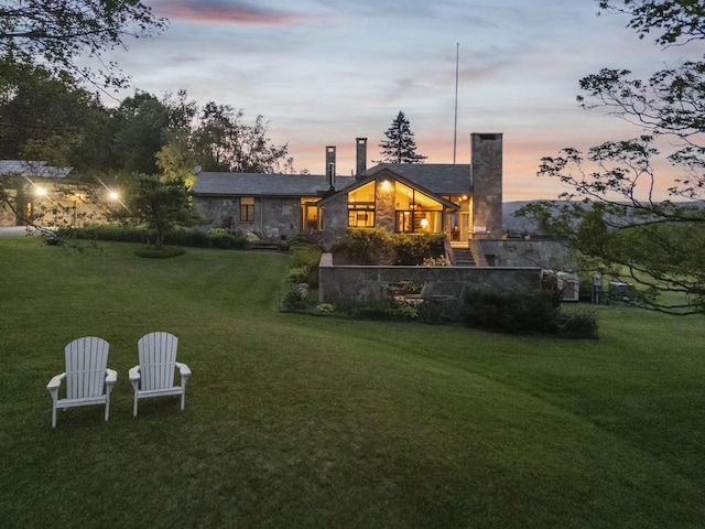 611 Simmons Rd, Andover, VT 05143 - back of property with a chimney, a yard, and stone siding