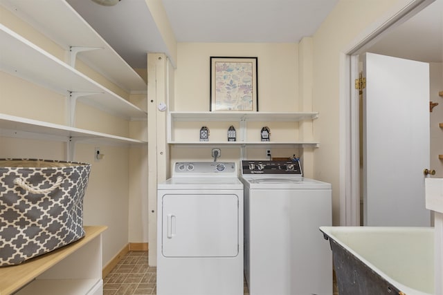 719 Roundabout Rd, Killington, VT 05751 - laundry room with brick patterned floors and washing machine and clothes dryer