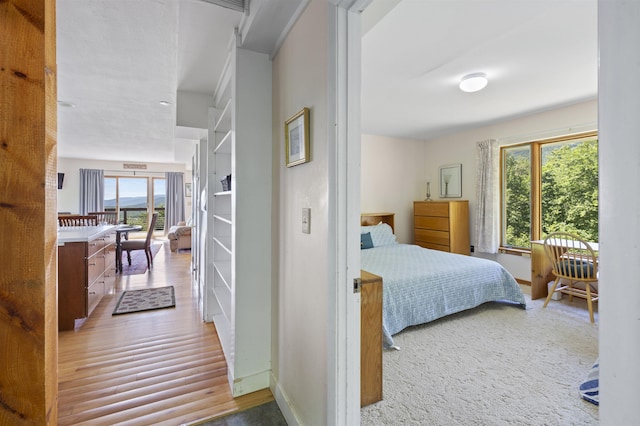 719 Roundabout Rd, Killington, VT 05751 - bedroom with multiple windows and wood finished floors