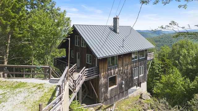 719 Roundabout Rd, Killington, VT 05751 - rear view of property with a chimney, a standing seam roof, and a metal roof
