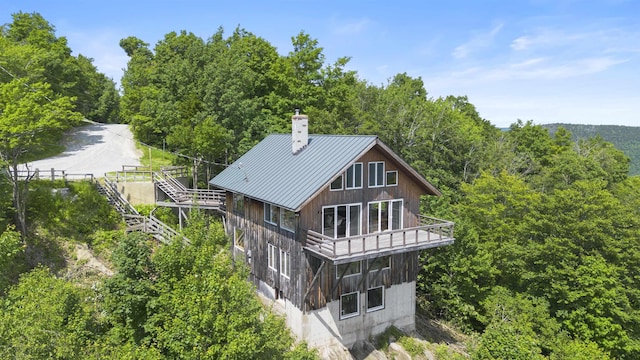 719 Roundabout Rd, Killington, VT 05751 - rear view of property with a chimney, a balcony, a metal roof, a forest view, and a standing seam roof