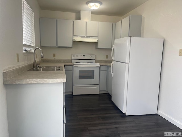 1145 Virbel Ln, Reno, NV 89502 - kitchen with white appliances, a sink, under cabinet range hood, light countertops, and dark wood-style floors