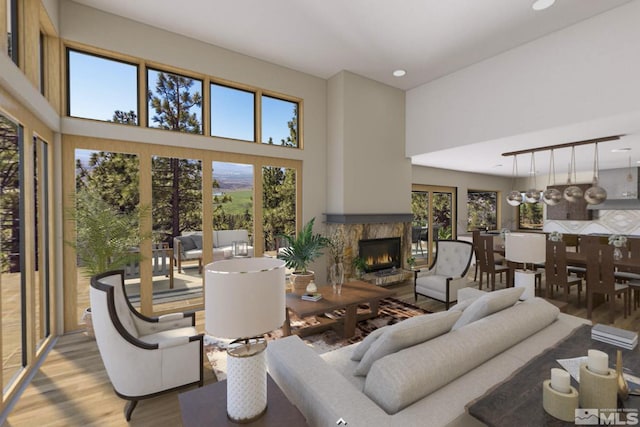 200 Overlook Dr Unit 29, Carson City, NV 89705 - living room with wood finished floors, a warm lit fireplace, a high ceiling, and recessed lighting