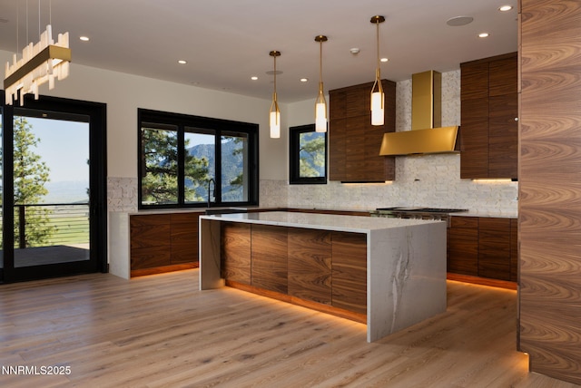 200 Overlook Dr Unit 29, Carson City, NV 89705 - kitchen with modern cabinets, wall chimney range hood, brown cabinets, light wood finished floors, and decorative backsplash