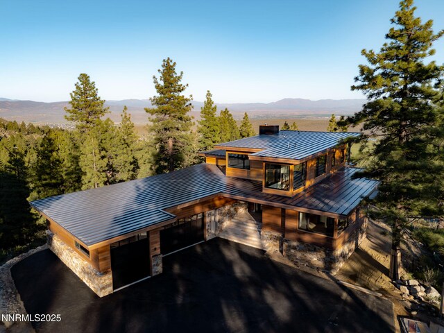 200 Overlook Dr Unit 29, Carson City, NV 89705 - view of front of property with a standing seam roof, metal roof, a chimney, stone siding, and a mountain view