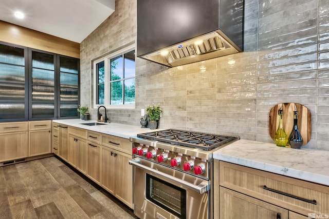 265 Mill Race Loop, Carson City, NV 89705 - kitchen with designer range, light brown cabinets, a sink, backsplash, and wall chimney range hood