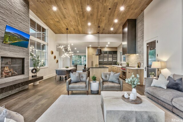 265 Mill Race Loop, Carson City, NV 89705 - living room with wooden ceiling, wood finished floors, a stone fireplace, recessed lighting, and baseboards