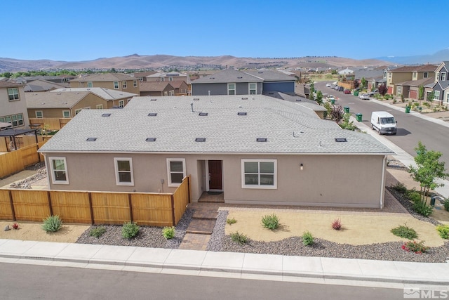 7732 Boulder Falls Dr, Sparks, NV 89436 - view of front of home with a residential view, fence, a mountain view, and stucco siding