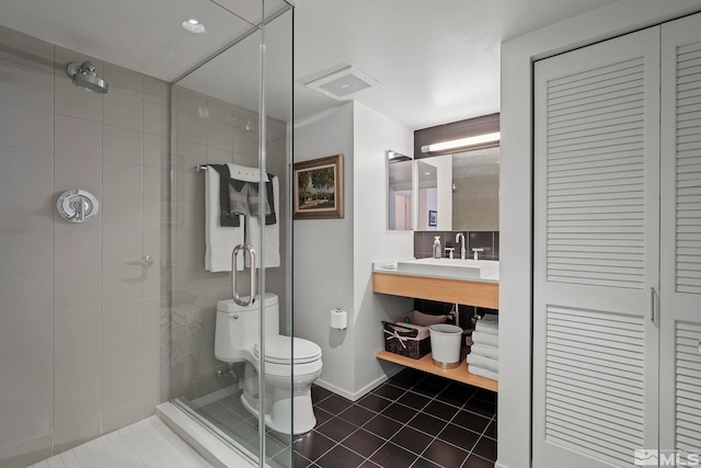 255 N Sierra St Unit 2013, Reno, NV 89501 - bathroom with a shower stall, tile patterned flooring, toilet, vanity, and a closet