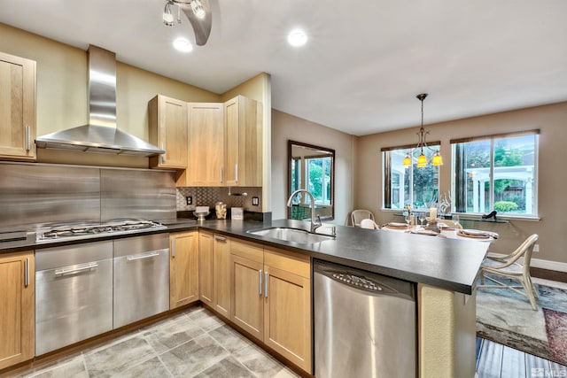 1008 Keystone Ct, Gardnerville, NV 89460 - kitchen featuring stainless steel appliances, wall chimney range hood, a sink, dark countertops, and a peninsula