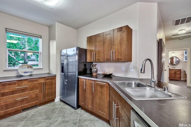1008 Keystone Ct, Gardnerville, NV 89460 - kitchen featuring a sink, stainless steel fridge with ice dispenser, dark countertops, and brown cabinetry
