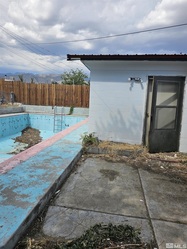 116 English St, Hawthorne, NV 89415 - view of side of home featuring a fenced backyard, concrete block siding, and a patio
