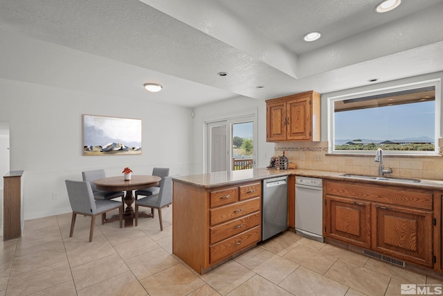 1663 Mackland Dr, Minden, NV 89423 - kitchen with a sink, dishwasher, a peninsula, decorative backsplash, and brown cabinets