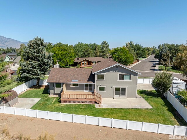1663 Mackland Dr, Minden, NV 89423 - back of property featuring a wooden deck, a patio, and a shingled roof
