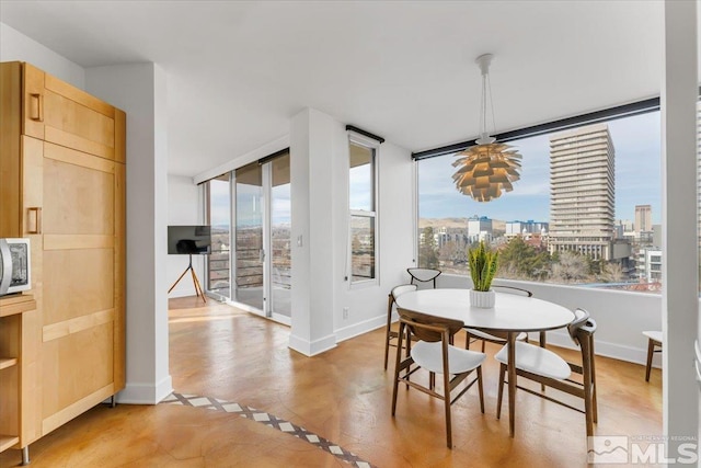 280 Island Ave Unit 803, Reno, NV 89501 - dining space featuring plenty of natural light, baseboards, a view of city, and light wood-style flooring