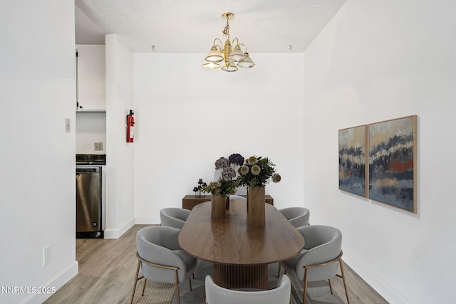 1000 Beck St Unit 276, Reno, NV 89509 - dining area with a chandelier, light wood-style flooring, and a textured ceiling