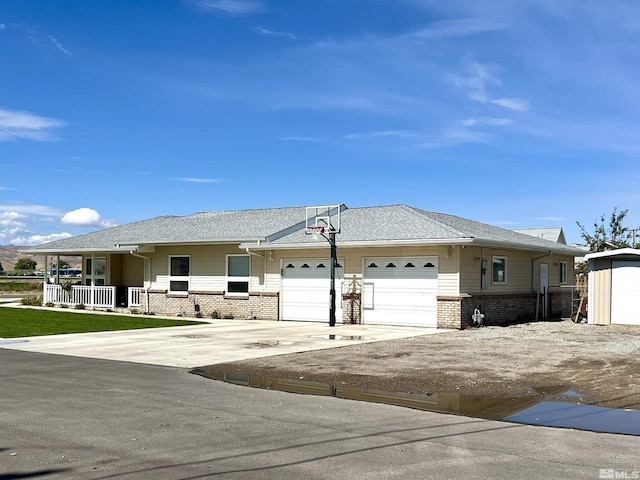 310 N Mountain View St, Yerington, NV 89447 - view of front of house with brick siding, a garage, and driveway