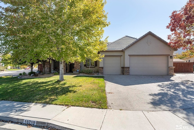 10710 Ivy Gate, Reno, NV 89521 - view of front of property featuring stone siding, a garage, stucco siding, driveway, and a tile roof
