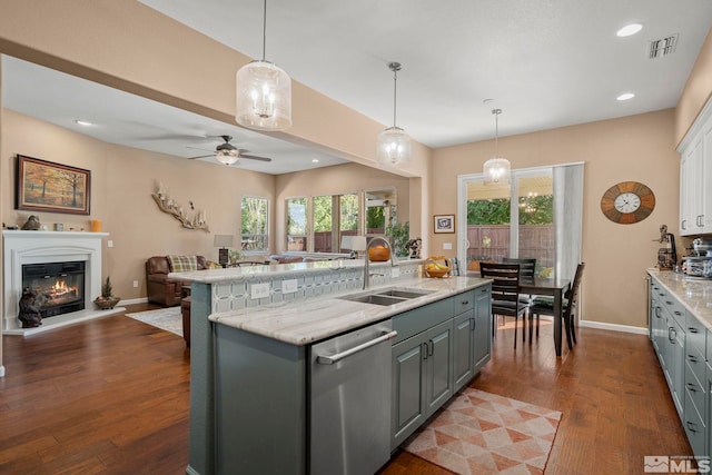 10710 Ivy Gate, Reno, NV 89521 - kitchen featuring dishwasher, a sink, open floor plan, baseboards, and an island with sink