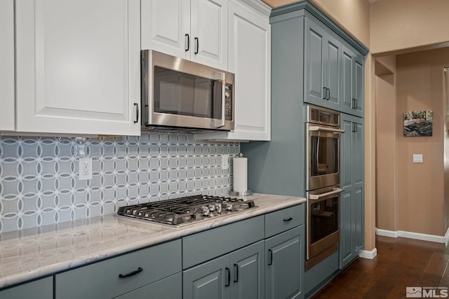 10710 Ivy Gate, Reno, NV 89521 - kitchen featuring stainless steel appliances, backsplash, baseboards, dark wood-style flooring, and light stone countertops