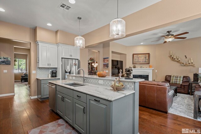 10710 Ivy Gate, Reno, NV 89521 - kitchen with gray cabinetry, stainless steel appliances, white cabinetry, open floor plan, and a sink