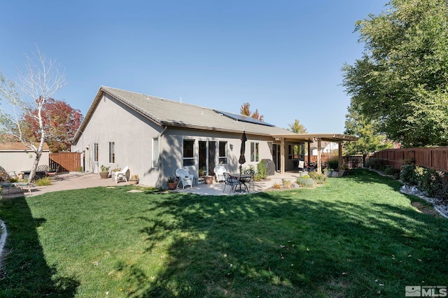 10710 Ivy Gate, Reno, NV 89521 - back of property featuring solar panels, a patio area, and stucco siding
