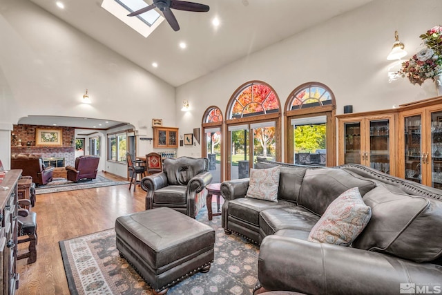 1865 Olive Ln, Reno, NV 89511 - living area featuring a ceiling fan, high vaulted ceiling, wood finished floors, recessed lighting, and a brick fireplace