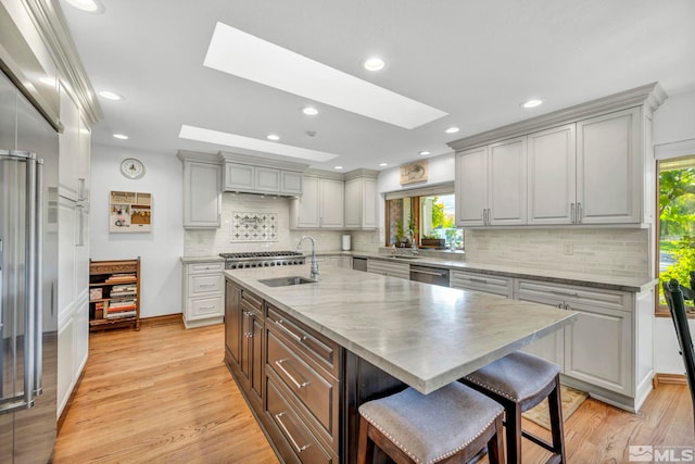 1865 Olive Ln, Reno, NV 89511 - kitchen featuring dishwasher, a skylight, healthy amount of natural light, a breakfast bar area, and recessed lighting