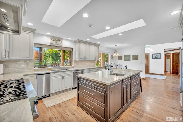 1865 Olive Ln, Reno, NV 89511 - kitchen featuring a skylight, stainless steel appliances, a sink, and recessed lighting