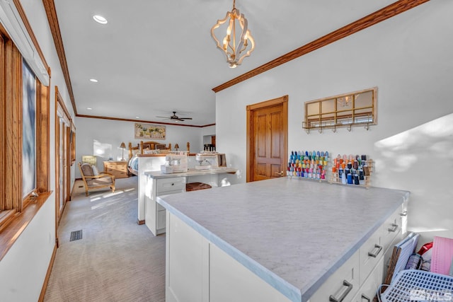 1865 Olive Ln, Reno, NV 89511 - kitchen with crown molding, white cabinetry, a peninsula, light countertops, and ceiling fan