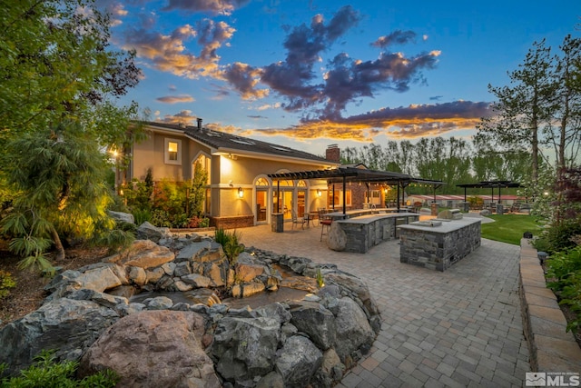 1865 Olive Ln, Reno, NV 89511 - patio terrace at dusk with a pergola and area for grilling