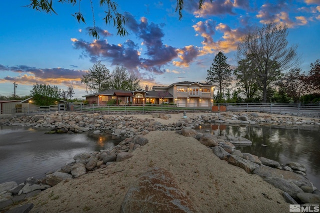 1865 Olive Ln, Reno, NV 89511 - back of house at dusk featuring a water view and fence