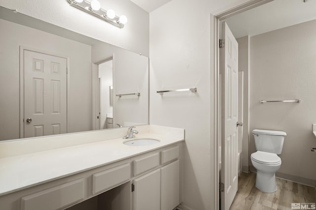 2311 Sycamore Glen Dr Unit 4, Sparks, NV 89434 - bathroom with wood finished floors, toilet, vanity, and baseboards
