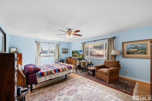 14005 N Red Rock Rd, Reno, NV 89508 - bedroom with multiple windows, wood finished floors, baseboards, and ceiling fan