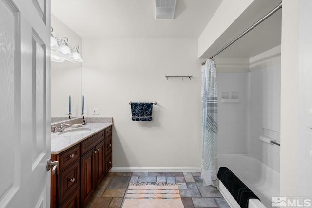 14005 N Red Rock Rd, Reno, NV 89508 - bathroom with vanity, baseboards, stone tile flooring, and shower / bath combination with curtain