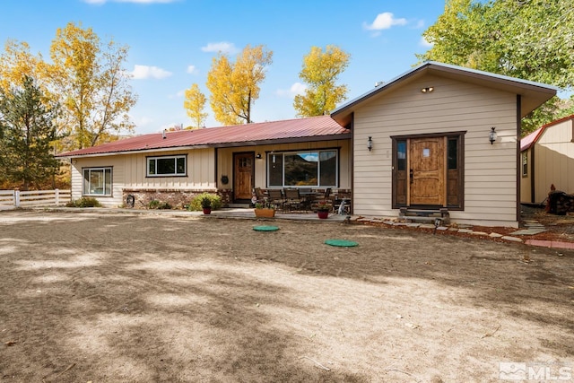 14005 N Red Rock Rd, Reno, NV 89508 - view of front of home with fence, board and batten siding, metal roof, brick siding, and covered porch