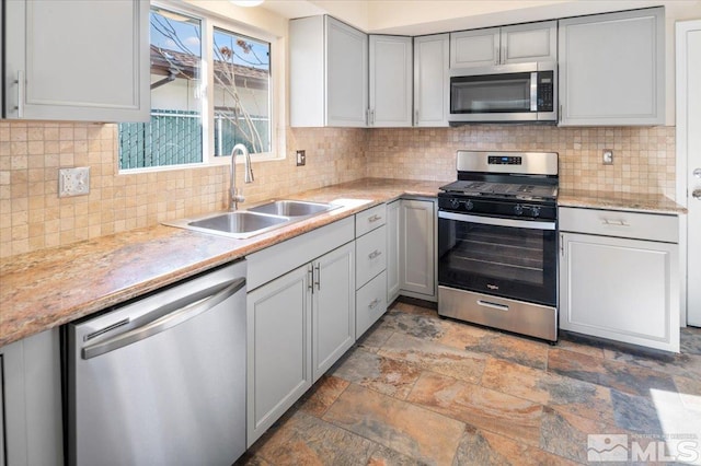 630 Teel St, Sparks, NV 89431 - kitchen with appliances with stainless steel finishes, a sink, gray cabinets, light countertops, and light stone finish floors