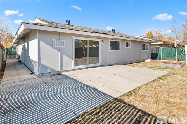 630 Teel St, Sparks, NV 89431 - rear view of property with board and batten siding, a patio, and fence