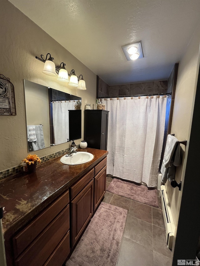 3205 Saint Clair Rd, Fallon, NV 89406 - bathroom featuring baseboard heating, vanity, curtained shower, and a textured wall