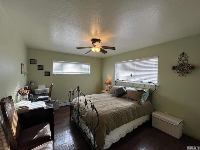 3205 Saint Clair Rd, Fallon, NV 89406 - bedroom featuring dark wood-style flooring, baseboard heating, ceiling fan, and a textured ceiling