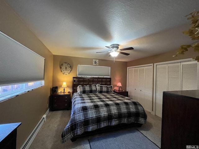 3205 Saint Clair Rd, Fallon, NV 89406 - carpeted bedroom featuring baseboard heating, multiple closets, ceiling fan, and baseboards