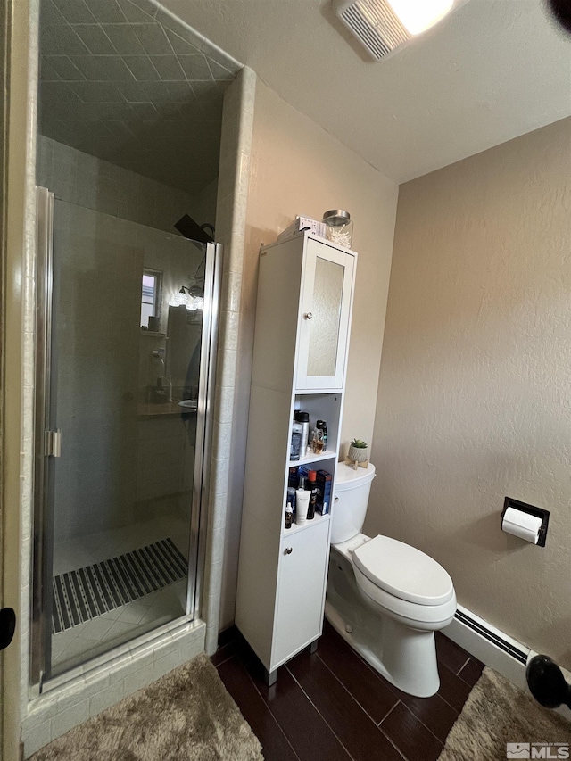 3205 Saint Clair Rd, Fallon, NV 89406 - full bath with a stall shower, toilet, a baseboard radiator, and wood finished floors