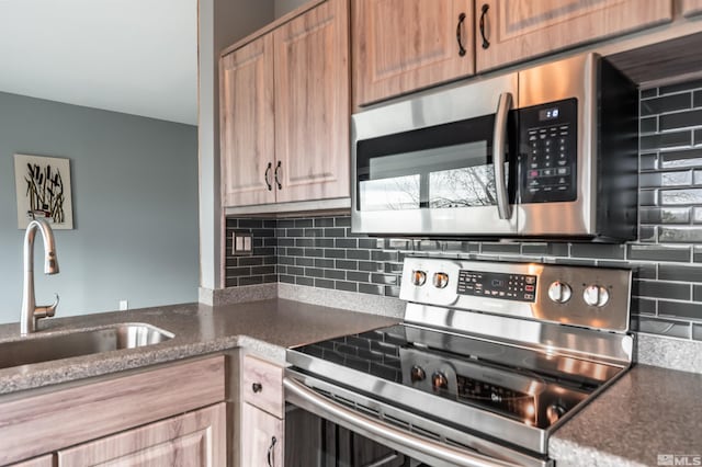 3061 Cashill Blvd, Reno, NV 89509 - kitchen with stainless steel appliances, a sink, backsplash, and dark stone counters
