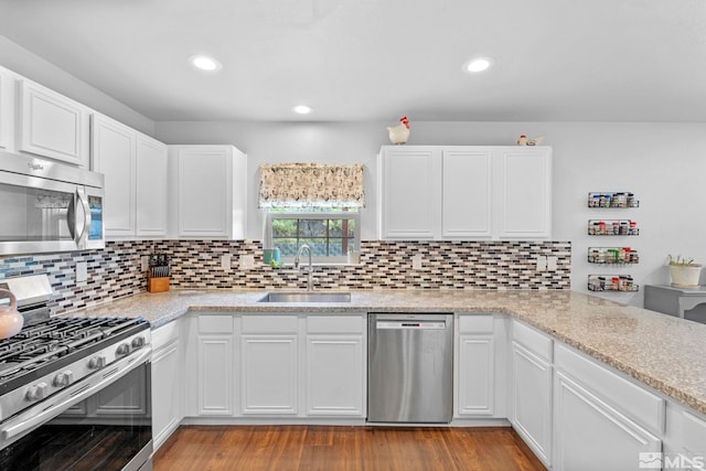 17850 Brushland Dr, Reno, NV 89508 - kitchen with stainless steel appliances, a sink, backsplash, white cabinetry, and recessed lighting