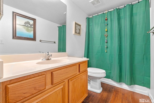 17850 Brushland Dr, Reno, NV 89508 - bathroom featuring toilet, wood finished floors, vanity, and shower / bath combination with curtain