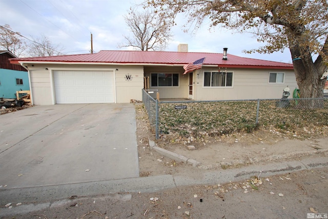 101 Hermansen, Hawthorne, NV 89415 - ranch-style home featuring a fenced front yard, an attached garage, concrete driveway, metal roof, and a chimney