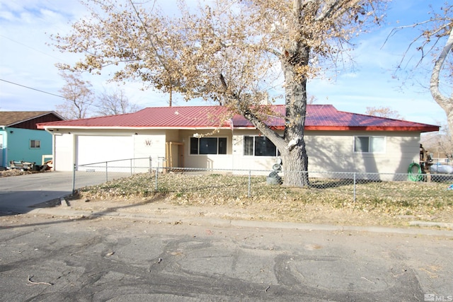 101 Hermansen, Hawthorne, NV 89415 - single story home with metal roof, a fenced front yard, and concrete driveway